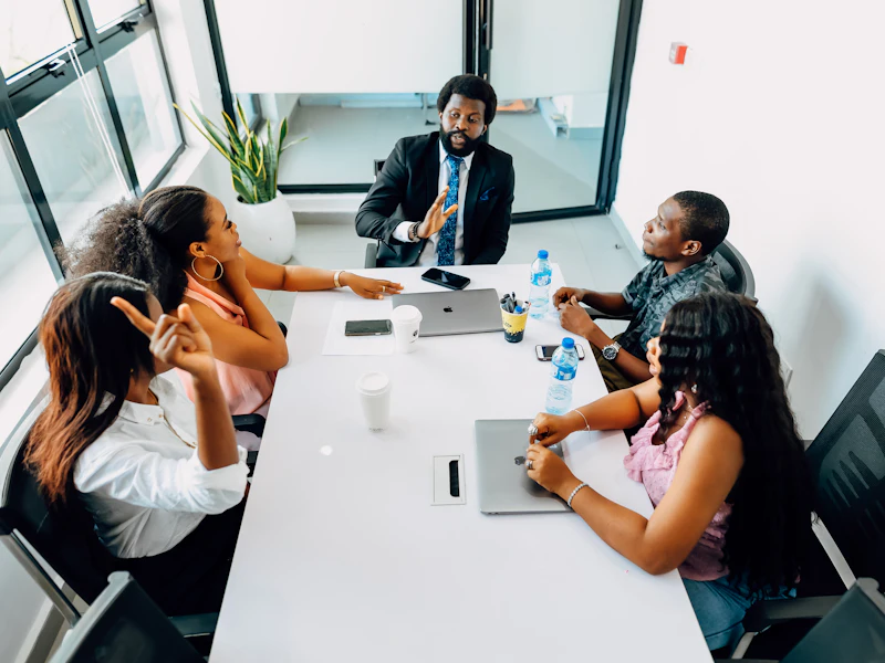Colleagues talking through a plan around a table