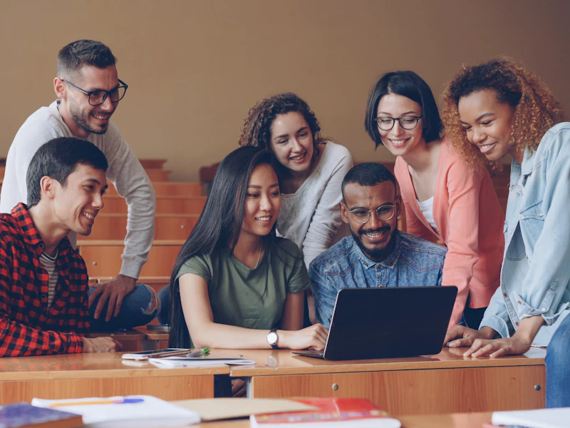A group gathered around a laptop during a hands-on session