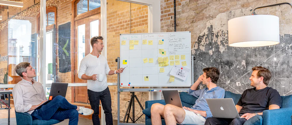 A facilitator leading a workshop at a whiteboard
