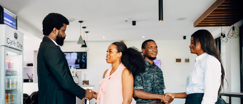 People greeting one another at the start of a meeting