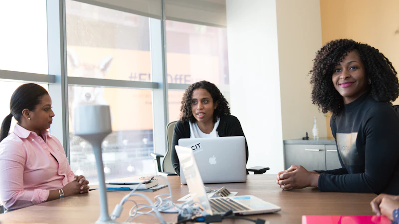 Colleagues in conversation around a meeting table